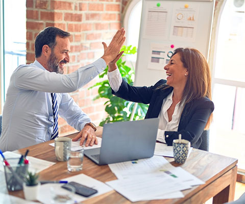 Two business colleagues high-fiving each other