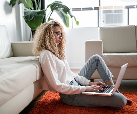 Woman using laptop in living room