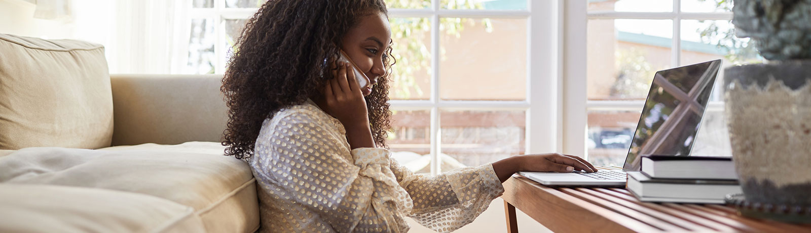 Young woman using laptop in living room